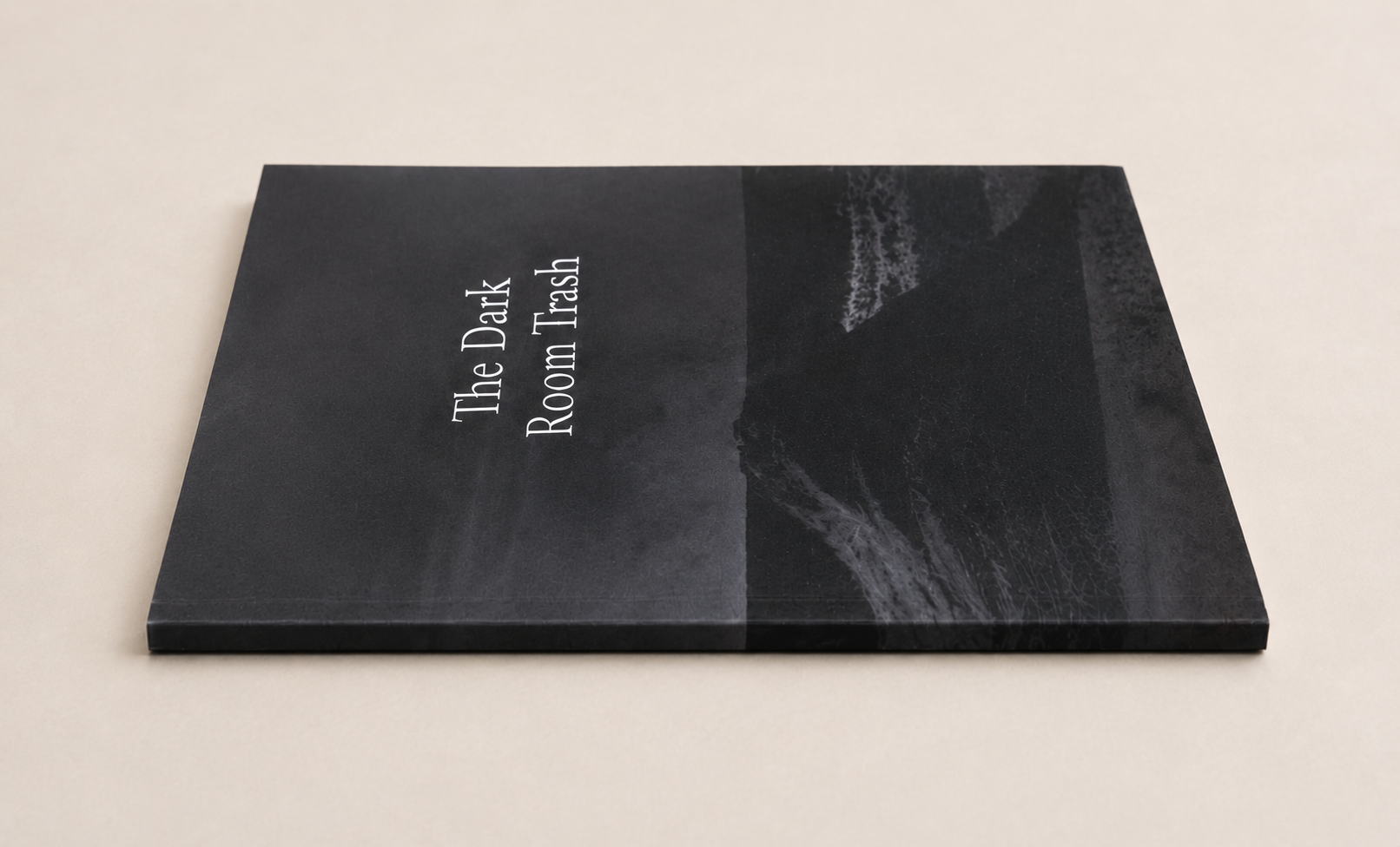 The Dark Room Trash book photographed from a low angle as a physical book object